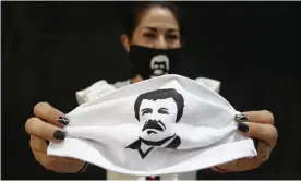  ?? Photograph: Francisco Guasco/EPA ?? A person holds a face mask, which depicts Joaquín ‘El Chapo’ Guzmán, in Guadalajar­a, Mexico. Jesús ‘El Rey’ Zambada gave evidence against the drug lord at his trial in New York.