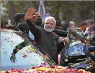  ?? SAJJAD HUSSAIN/ AFP/GETTY IMAGES ?? India’s Prime Minister Narendra Modi waves to his supporters during a roadshow ahead of the BJP national executive meet in New Delhi on Monday.