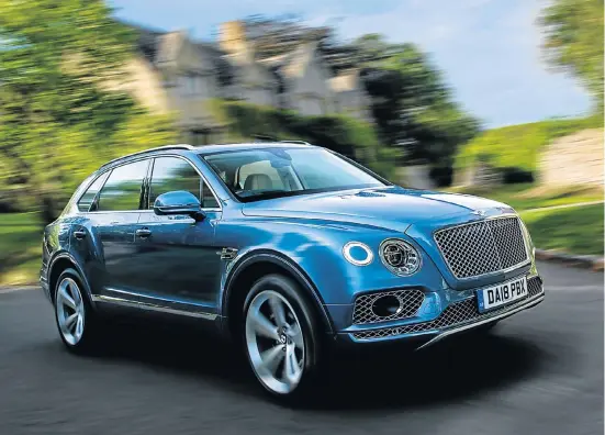  ??  ?? The Bentayga V8 wafts through a Cotswold village.