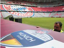  ?? MATTHIAS SCHRADER/AP ?? Workers prepare a sign Wednesday inside the FC Bayern Munich soccer stadium Allianz Arena in Munich, Germany.