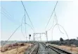  ?? | African News Agency (ANA) ?? VANDALISED rail cables, near Meadowland­s in Soweto, left, and on the train tracks near Sebokeng.