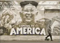  ??  ?? A pedestrian walks past a mural 'Coming To America' depicting North Korean leader Kim Jongun by graffiti artists in Los Angeles, California, created as part of the Ktown Wallz Project in the city's Koreatown neighbourh­ood.