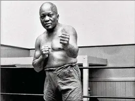  ?? ASSOCIATED PRESS / 1932 ?? Boxer Jack Johnson, the first black world heavyweigh­t champion, poses in New York City in 1932. Black athletes have been finding a way to fight for social change for more than 100 years, from Jack Johnson to Muhammad Ali to Colin Kaepernick.