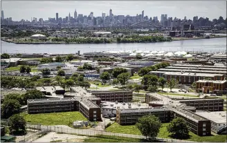  ?? SETH WENIG—ASSOCIATED PRESS ?? This Tuesday Dec. 2, 2014, file photo shows the Rikers Island jail complex in the foreground within the East River and the New York skyline in the background. Nearly all female and transgende­r inmates at New York City’s Rikers Island jail complex will be moved to state lockups in nearby Westcheste­r County to relieve strain on the city’s failing jails, Gov. Kathy Hochul said Wednesday, Oct. 13, 2021