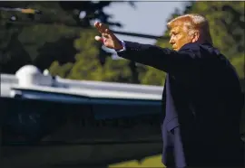  ?? ALEX BRANDON — THE ASSOCIATED PRESS ?? President Donald Trump waves as he walks to Marine One on the South Lawn of the White House on Wednesday. Trump was en route to Texas.