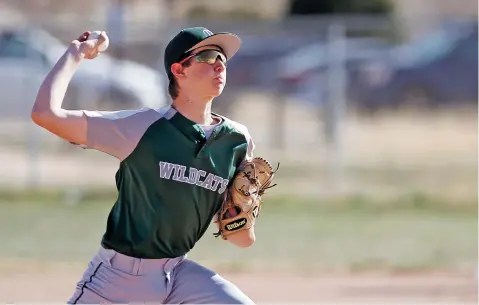  ?? PHOTOS BY LUIS SÁNCHEZ SATURNO/THE NEW MEXICAN ?? Desert Academy’s Cameron Motola pitches during the top of the second inning of Tuesday’s game against Peñasco at the Municipal Recreation Complex. Desert Academy won, 10-0.