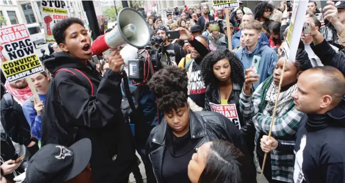  ?? JAMES FOSTER/FOR THE SUN-TIMES ?? Maria Hernandez, an organizer with Black Lives Matter, speaks to the crowd gathered outside of City Hall on Friday after the Van Dyke verdict was announced.