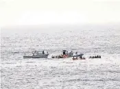  ?? RAFFAELE MARTINO, MARINA MILITARE, VIA AP ?? Rescuers help migrants board dinghies to tow them to an Italian ship after the boat they were aboard sunk. Sailors rescued 135 people and recovered 45 bodies.