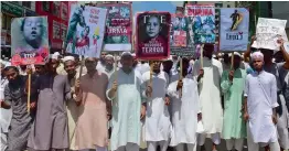  ?? — AFP ?? Members of Islamist groups hold placards and shout slogans during a rally to siege Myanmar’s embassy Dhaka on Monday.