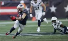  ?? CHARLES KRUPA — THE ASSOCIATED PRESS ?? Patriots wide receiver Julian Edelman (11) runs after catching a pass against the Chargers during the second half on Sunday in Foxborough, Mass.