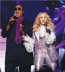  ?? (Mario Anzuoni/Reuters) ?? SUPERSTARS MADONNA and Stevie Wonder perform at the 2016 Billboard Awards.
