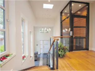  ??  ?? Below: A glass elevator awaits for those who don’t want to climb the stairs in this home.