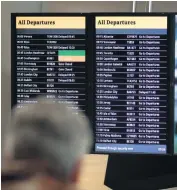  ?? PA ?? Airport: An air traveller watches the departures board