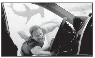 ??  ?? Fin Shepard (Ian Ziering) struggles to reach his chainsaw to battle the sharks in Sharknado 3: Oh Hell No!, airing Wednesday on Syfy.