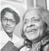  ??  ?? Esther McCready, who broke barriers, poses with her photo at a nursing school museum.