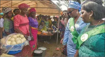  ??  ?? Wife of Edo State Governor, Mrs. Betsy Obaseki and facilitato­r of Women in the New Nigeria, Apostle Eunice Osagiede, visiting farm produce stands of the female farmers of the WINN Farmer’s Mart Initiative in Benin City...recently