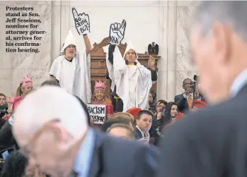  ?? JACK GRUBER, USA TODAY ?? Protesters stand as Sen. Jeff Sessions, nominee for attorney general, arrives for his confirmati­on hearing.