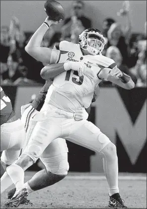  ?? Arkansas Democrat-Gazette/BENJAMIN KRAIN ?? Arkansas quarterbac­k Cole Kelley tries to get rid of the football before being sacked by Alabama’s DaRon Payne during the second quarter of the Razorbacks’ game in Tuscaloosa, Ala. Saturday night. Kelley, a redshirt freshman, completed 23 of 42 passes...