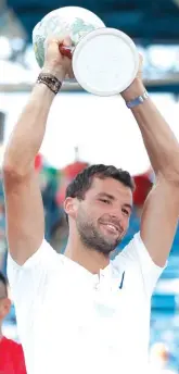  ??  ?? Grigor Dimitrov, of Bulgaria, celebrates with the trophy after defeating Nick Kyrgios