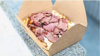  ?? ?? As a nod to owner Marc Perreault’s Montreal background, there’s a smoked meat poutine on the menu at NomNomNom.