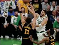  ?? STEVEN SENNE — THE ASSOCIATED PRESS ?? Boston Celtics forward Jayson Tatum puts up a shot against Golden State Warriors guard Klay Thompson and forward Andrew Wiggins during the fourth quarter of Game 3 on Wednesday.