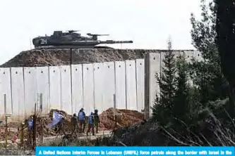  ??  ?? A United Nations Interim Forces in Lebanon (UNIFIL) force patrols along the border with Israel in the southern Lebanese village of Adaisseh. —AFP