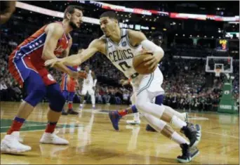  ?? ELISE AMENDOLA — THE ASSOCIATED PRESS ?? Boston Celtics forward Jayson Tatum, right, drives against Sixers guard Marco Belinelli in the second half Monday night. Tatum had already driven the Sixers’ J.J. Redick nuts trying to cover him earlier.