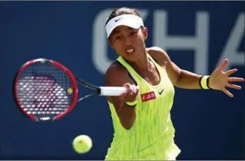  ?? JOE SCARNICI / GETTY IMAGES / AFP ?? Zhang Shuai of China returns a shot to Ellen Perez of Australia during her first round women’s singles match on the second day of the 2016 US Open at the USTA Billie Jean King National Tennis Center on Tuesday in Queens, New York.