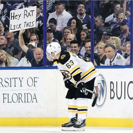  ?? MIKE EHRMANN/GETTY IMAGES ?? A Tampa Bay fan lets Brad Marchand of the Boston Bruins know exactly what he thinks of the star forward during a recent second-round playoff game against the Lightning. Marchand is under fire from NHL brass for licking opposing players.