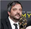  ?? (Monica Almeida/Reuters) ?? ADAM SCHLESINGE­R poses last year with an Emmy Award for Outstandin­g Original Music and Lyrics for ‘Crazy Ex-Girlfriend.’