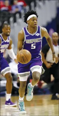  ?? ROB CARR/GETTY IMAGES/TNS ?? De'Aaron Fox (5) of the Sacramento Kings brings the ball up against the Washington Wizards in Washington, D.C., on March 11, 2019.