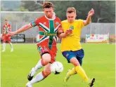  ?? ?? Danny Horscroft (left) battles for the ball.