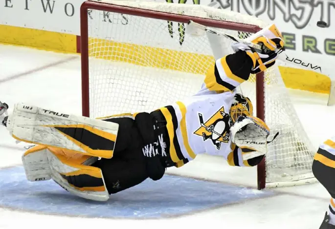  ?? Associated Press ?? Goaltender Casey DeSmith deflects the puck in the second period of the Penguins’ 6-4 win over the New Jersey Devils Friday night in Newark, N.J.