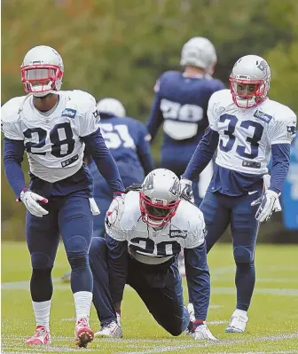  ?? STAFF PHOTO BY JOHN WILCOX ?? THREE HORSEMEN: Running backs James White, LeGarrette Blount and Dion Lewis get loose at the start of practice yesterday in Foxboro.