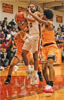  ?? STAFF PHOTO BY TROY STOLT ?? Tyner’s Melique Hambrick grabs a rebound during Thursday night’s home game against rival Howard. The Rams are one win from advancing to the TSSAA Class AA state tournament.