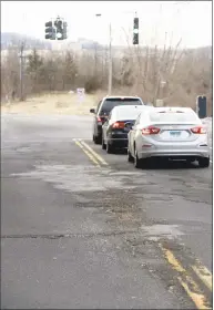  ?? H John Voorhees III / Hearst Connecticu­t Media ?? Pot holes and rough road surface on Park Avenue, at its intersecti­on with Segar Street on Thursday in Danbury.