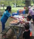  ??  ?? A city youth grabs a free hotdog during the 12th annual Community Day event hosted by Fathers and Men United For a Better Trenton at Cadwalader Park Saturday.