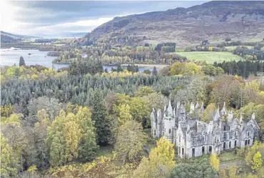  ?? ?? ↑ The ruins of Dunalastai­r House, near Pitlochry, surrounded by trees displaying autumn colours