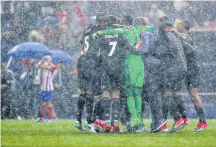  ?? AFP ?? Real Madrid players celebrate their qualificat­ion for the Champions League final at the Vicente Calderon stadium in Madrid.