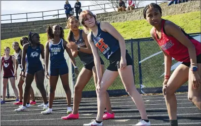  ?? (NWA Democrat-Gazette/Charlie Kaijo) ?? Runners wait for their teammates during the 1,000-meter Swedish relay Thursday at the Whitey Smith Relay Carnival in Rogers. The race consisted of four athletes running 100, 200, 300 and 400 meters in succession.