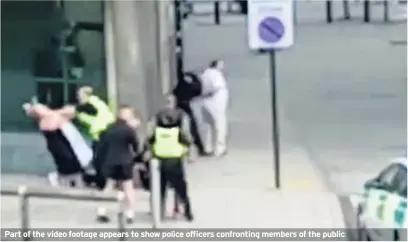  ??  ?? Part of the video footage appears to show police officers confrontin­g members of the public