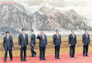  ?? REUTERS ?? China’s President Xi Jinping and other new Politburo Standing Committee members attend a meeting with the media in Beijing. No women made it into the elite committee.