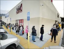  ?? Al Seib Los Angeles Times ?? SHOPPERS LINED UP early last March outside the Grocery Outlet Bargain Market in Altadena as the store opened before 7 a.m. to accommodat­e seniors.