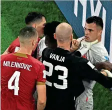  ?? AFP ?? No love lost: Serbia keeper Milinkovic-Savic grabs Xhaka by the throat