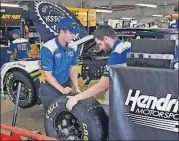  ?? [CHARLES KRUPA/THE ASSOCIATED PRESS] ?? The Hendrick Motorsport­s race crew for driver Chase Elliott prepare for practice prior to qualifying for the NASCAR Cup Series auto race at New Hampshire Motor Speedway on Friday in Loudon, N.H.