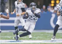  ?? ZACH BOLINGER/ASSOCIATED PRESS ?? Titans running back Derrick Henry cuts back inside during an Oct. 31 game against the Colts in Indianapol­is. Henry is one of 32 finalists for the Walter Payton NFL Man of the Year award.