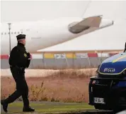  ?? Christophe Ena/Associated Press ?? A Gendarme walks in front the plane which reportedly carried some 300 Indian citizens, at the Vatry airport, Saturday, in Vatry, eastern France. About 300 Indian citizens heading to Central America were sequestere­d in a French airport for a third day Saturday because of an investigat­ion into suspected human traffickin­g, authoritie­s said.