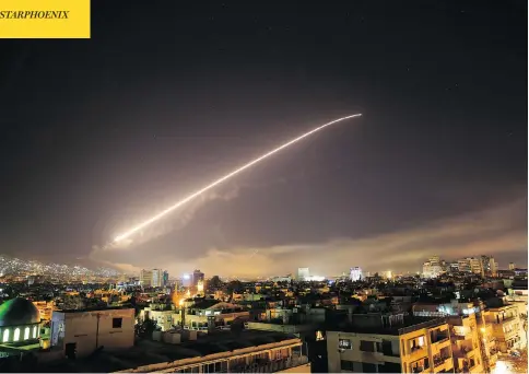  ?? HASSAN AMMAR / THE ASSOCIATED PRESS ?? Explosions and anti-aircraft fire light up the skies over the Syrian capital of Damascus early Saturday morning as the U.S. launches an attack on President Bashar al-Assad’s forces. The strikes by U.S. and coalition forces came in retaliatio­n for the...