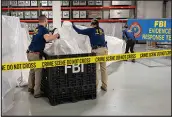  ?? FBI VIA AP ?? FBI special agents assigned to the evidence response team process material recovered from the high altitude balloon downed off the coast of South Carolina, Thursday at the FBI laboratory in Quantico, Va.