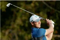  ?? — Reuters ?? Martin Kaymer of Germany tees off on the 12th hole during the first round in Abu Dhabi.